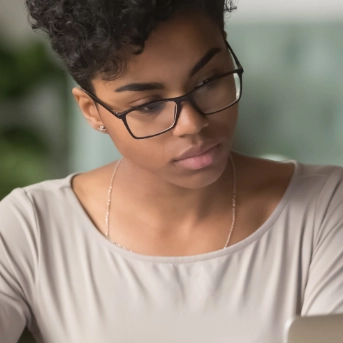 Woman studying data on a laptop